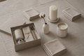 The Stone Gift Box Standard — natural undyed flax linen runner, undyed linen napkins, ivory pillar candle, matte white ceramic vase with dried cotton stem, hand-poured linen and eucalyptus candle
